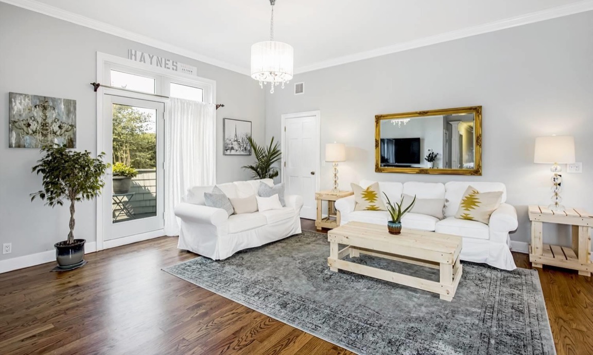 Living room with refinished oak floors, new trim and paint, and rustic wood end tables and a coffee table