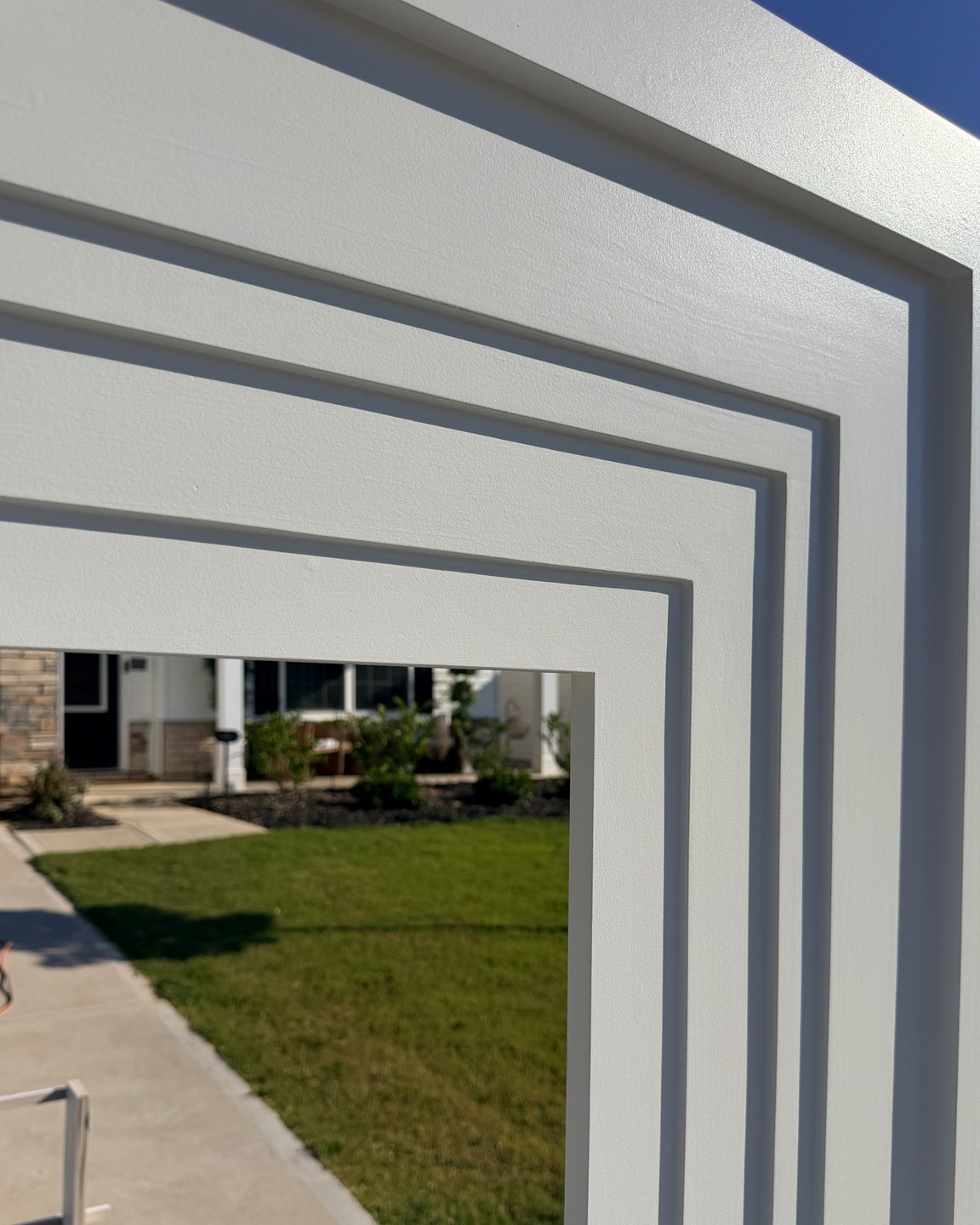 Layered trim profiles built up on a mantel surround, each step casting a clean shadow line
