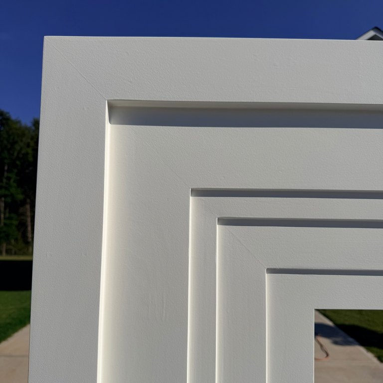 Upper corner of the surround, the nested profiles meeting cleanly at the miter